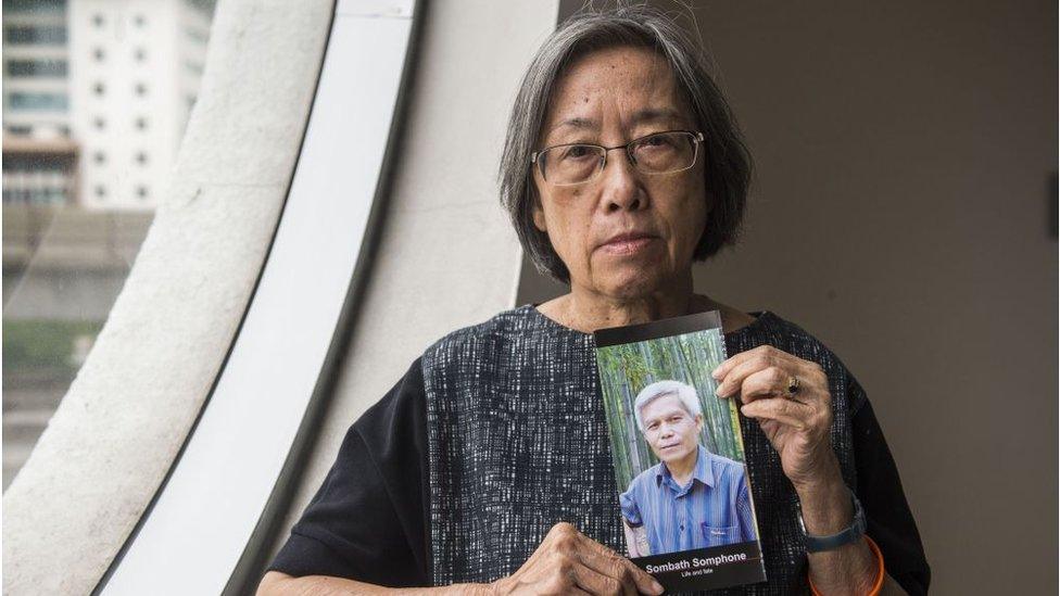 Shui Meng Ng holds a picture of her missing husband Sombath Somphone in December 2018