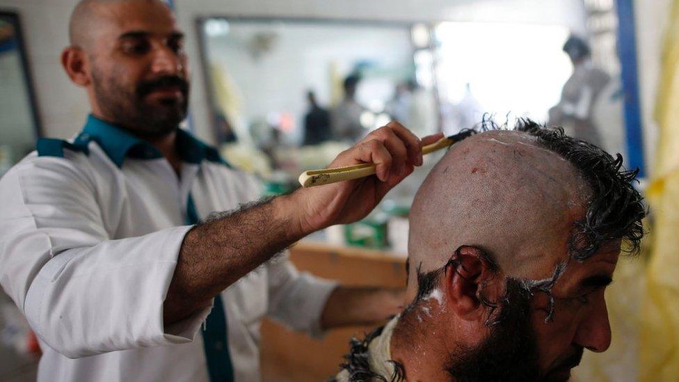 A pilgrim has his head shaved during the Hajj in Saudi Arabia