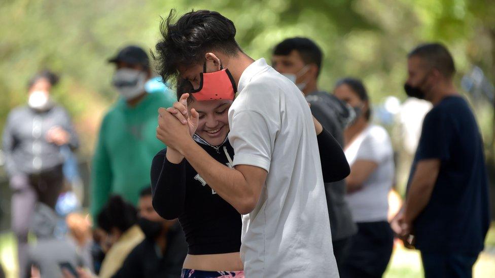 Venezuelan migrants dance at an improvised camp in Bogota on June 9, 2020.