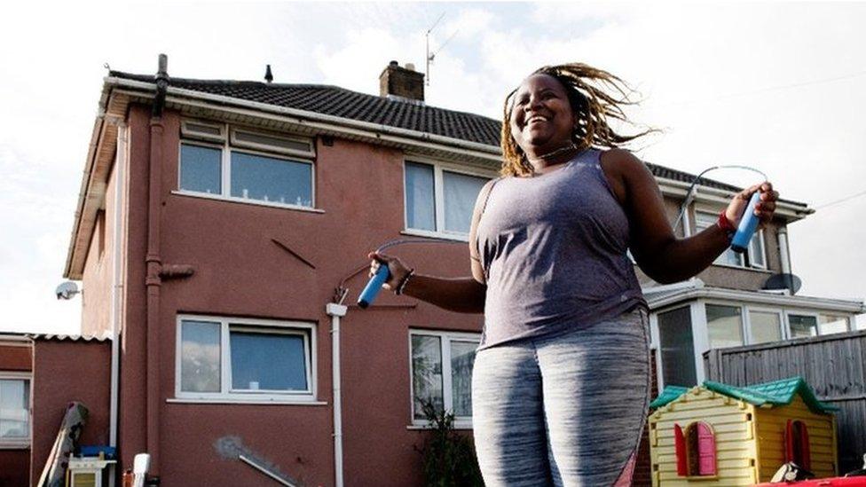 Esther Mutahinduka skipping in her garden