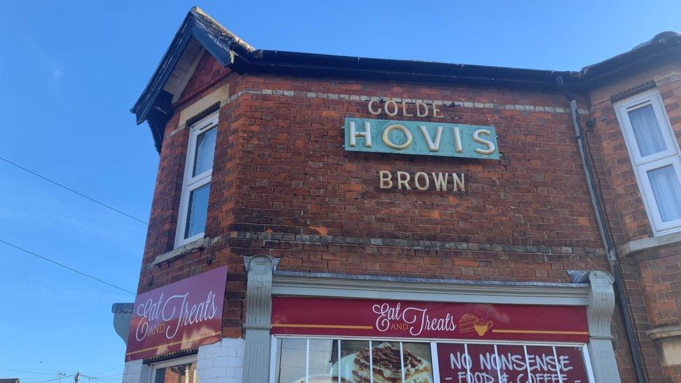 An old Hovis sign above an Italian deli in Bedford