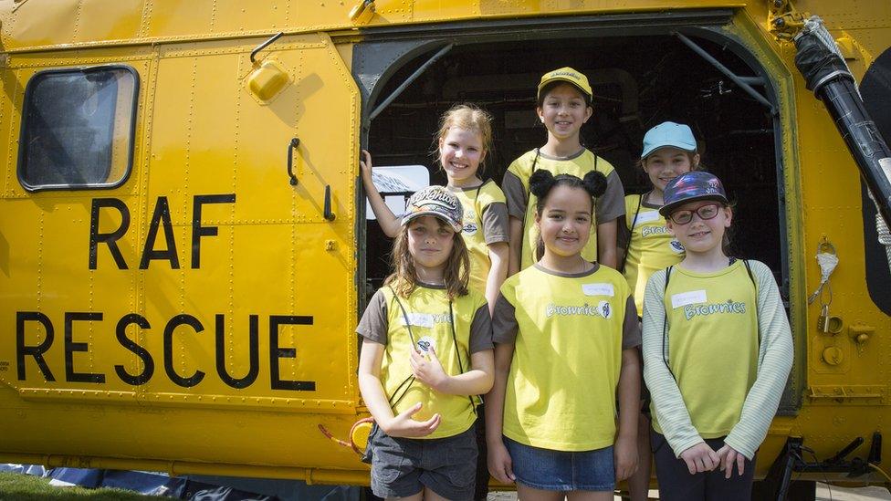 Cardiff brownies pose for a picture at the RAF Wessex helicopter which was one of the aircraft on display.