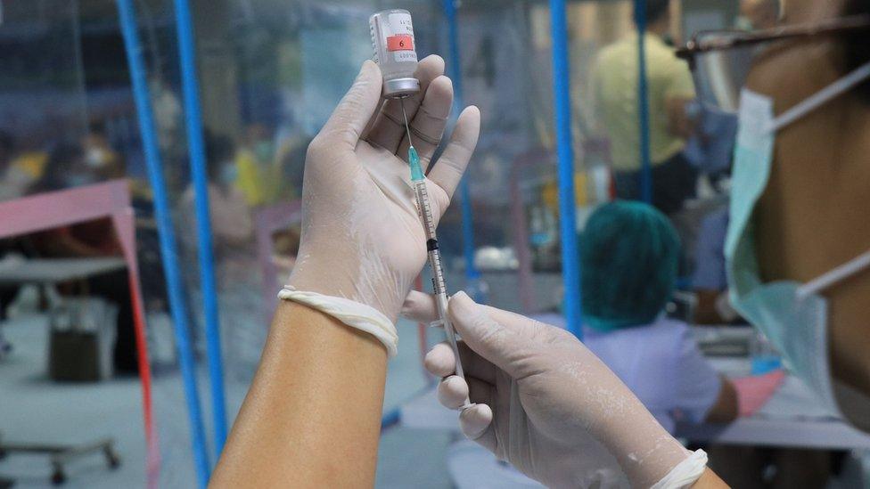 Syringe with vaccine in lab