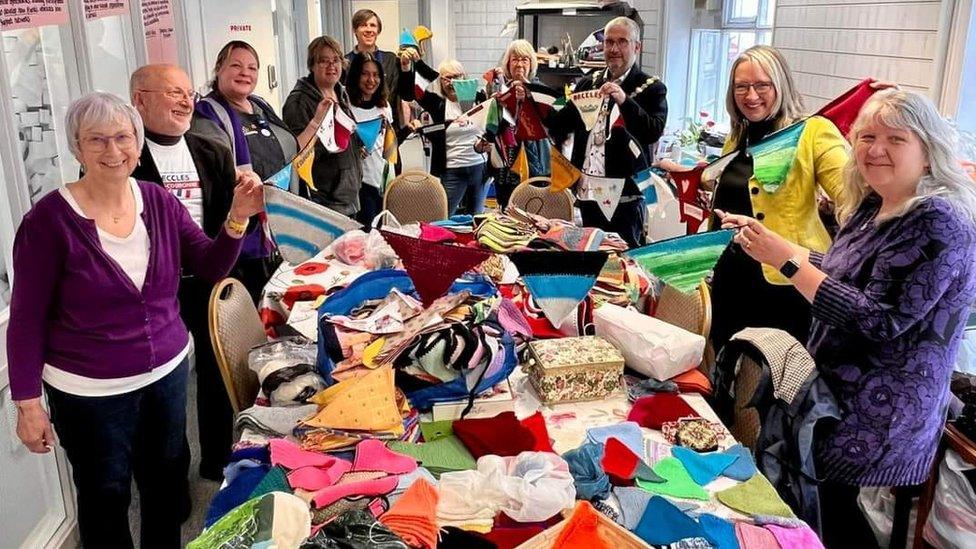 People from Beccles and Petit-Couronne holding up bunting