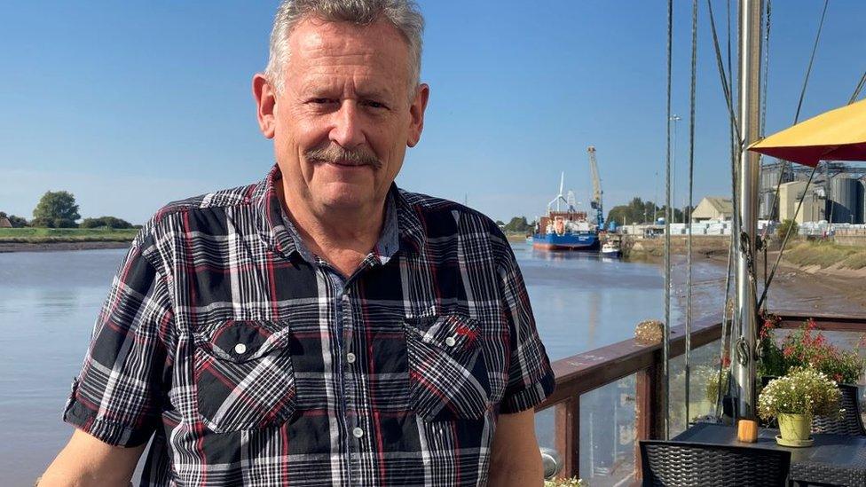 Kim Leonard, of King's Lynn Civic Society, in a shirt next to a river