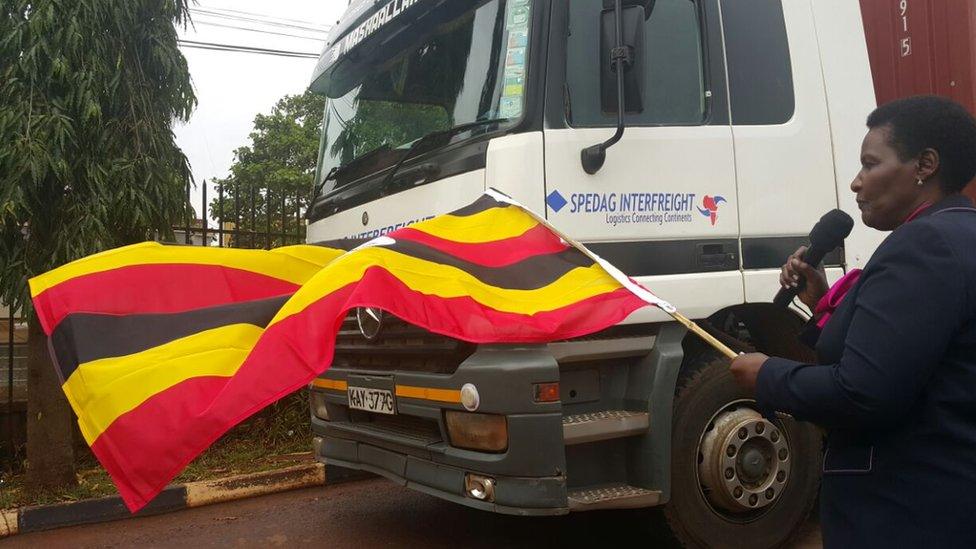 Lady holding Uganda flag