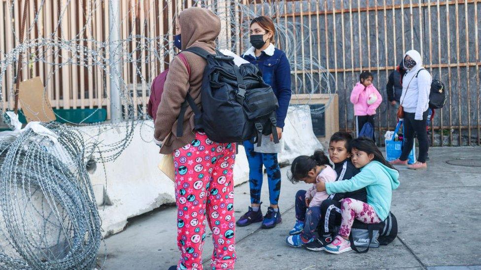 Pedestrians wait in line to cross the border at the San Ysidro Port of Entry on November 8, 2021 in Tijuana, Mexico