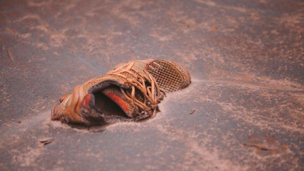 Personal items litter the mud which engulfed the villages