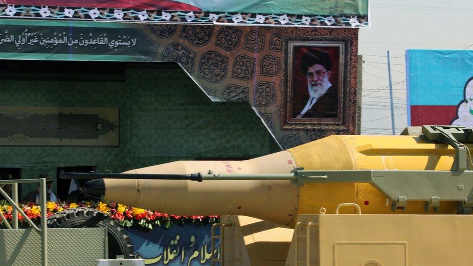 A military lorry carries a Qadr medium-range missile past a portrait of Iranian Supreme Leader Ayatollah Ali Khamenei, during the annual military parade on 22 September 2015