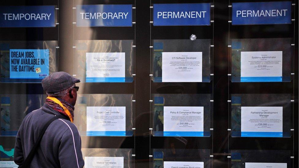 A man looking at job vacancies listed at a recruitment consultant in London