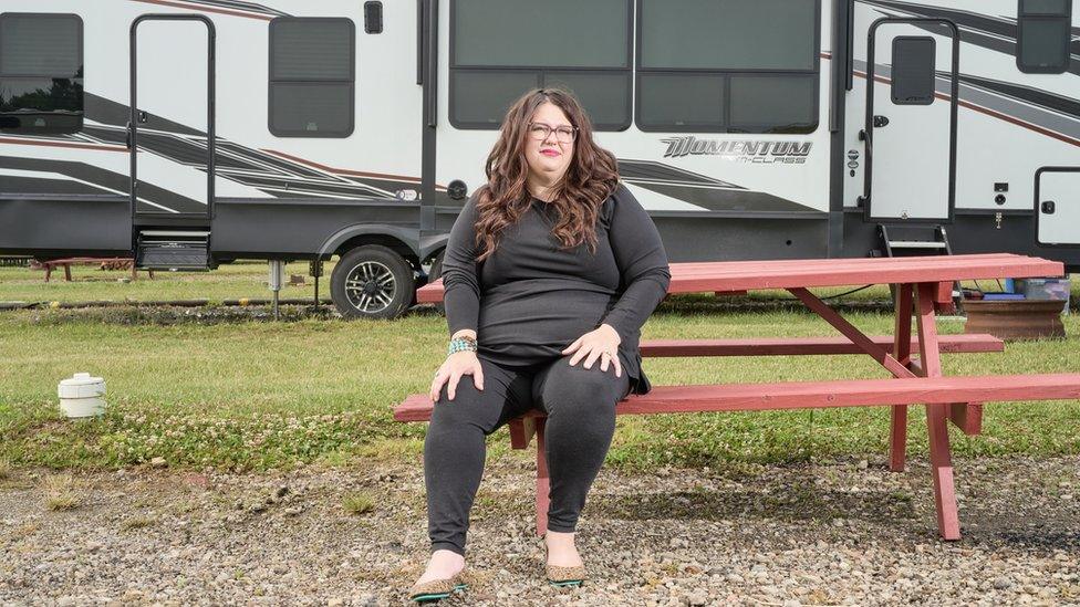 Kristan Hawkins sits in front of her motor home