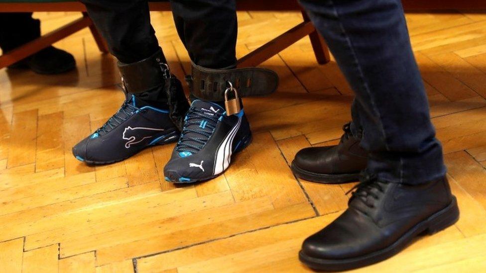 The chained feet of Syrian-Cypriot Ahmed Hamed at a courtroom in Szeged, Hungary, March 14 2018