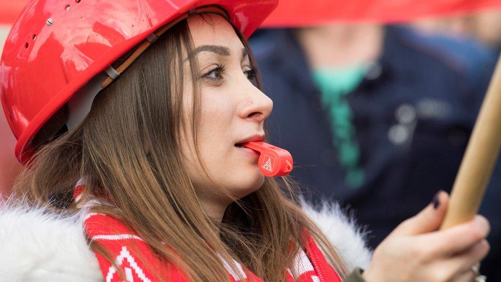 An employee of EvoBus, a subsidiary company of Daimler AG, blows her whistle during a warning strike called by the country"s largest union, the IG-Metall, in Mannheim,