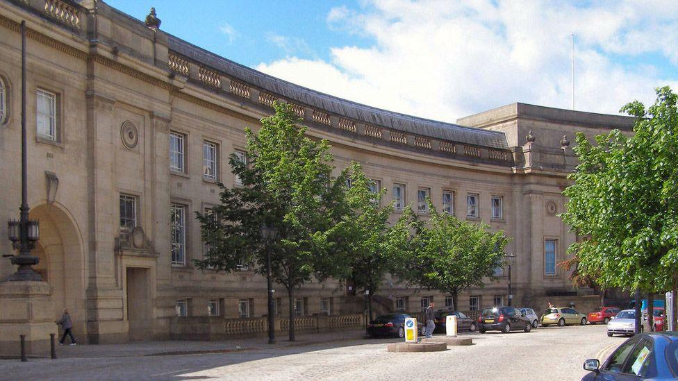 Street view of the curved architecture of Le Mans Crescent in Bolton