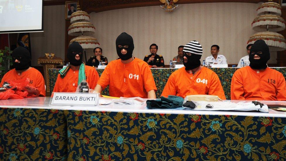 Five men who were arrested in Indonesia are paraded at a press conference