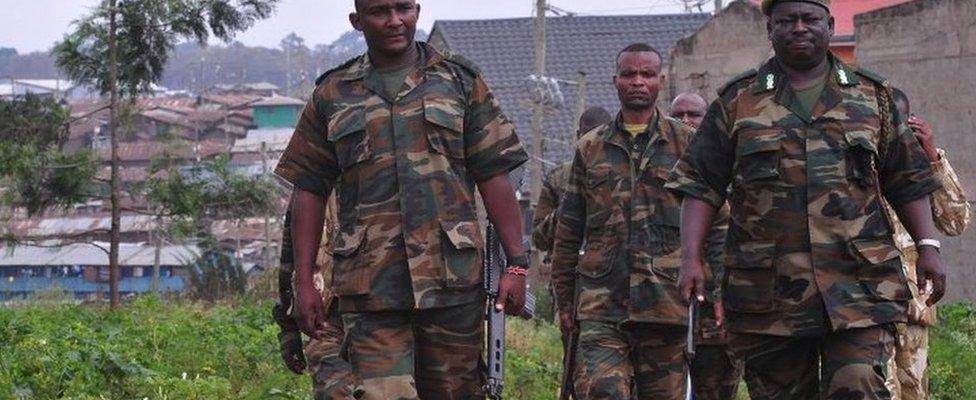 Kenya Wildlife Service (KWS) officers carrying tranquilizer guns