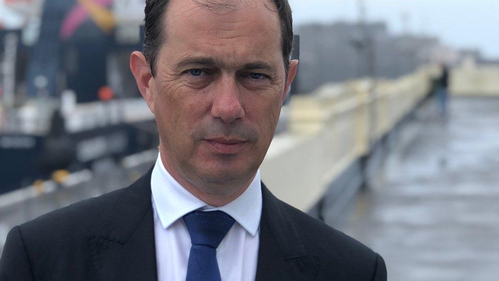 Man stood in front of a ferry