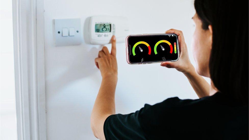 A woman looking at smart meter