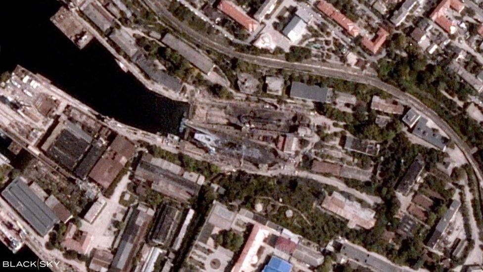 A satellite photo shows Sevastopol, Crimea after a Ukrainian missile attack, on September 12, 2023, with two blackened ships in the middle