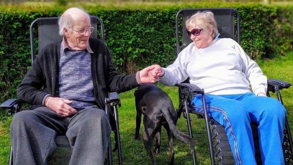 Betty and Ian sitting in their garden