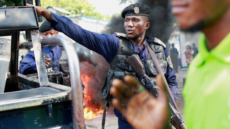 A police officer reacts during a protest near the United Nations' MONUSCO mission headquarters in downtown Kinshasa, Democratic Republic of Congo February 12, 2024