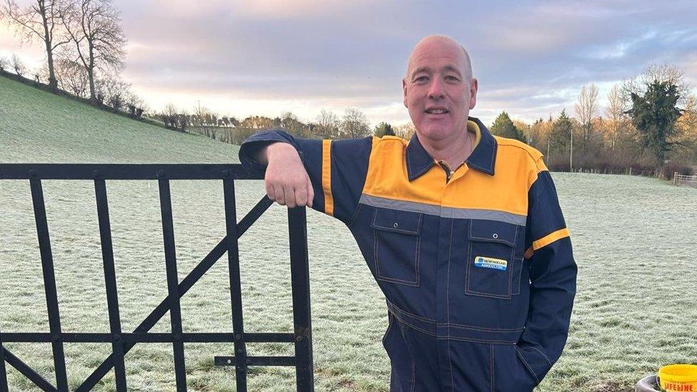 Farmer, George Carvill, stands in a field on his farm