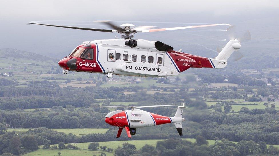 Undated handout photo issued by the Maritime and Coastguard Agency (MCA) of a helicopter with a drone. An unmanned aircraft will be deployed in UK coastguard search-and-rescue operations for the first time this weekend.