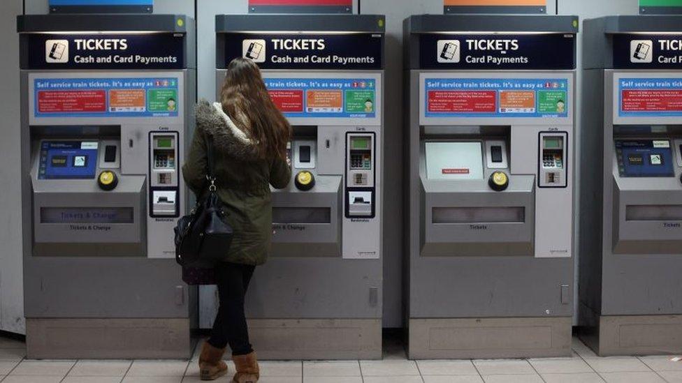 Woman buying train ticket