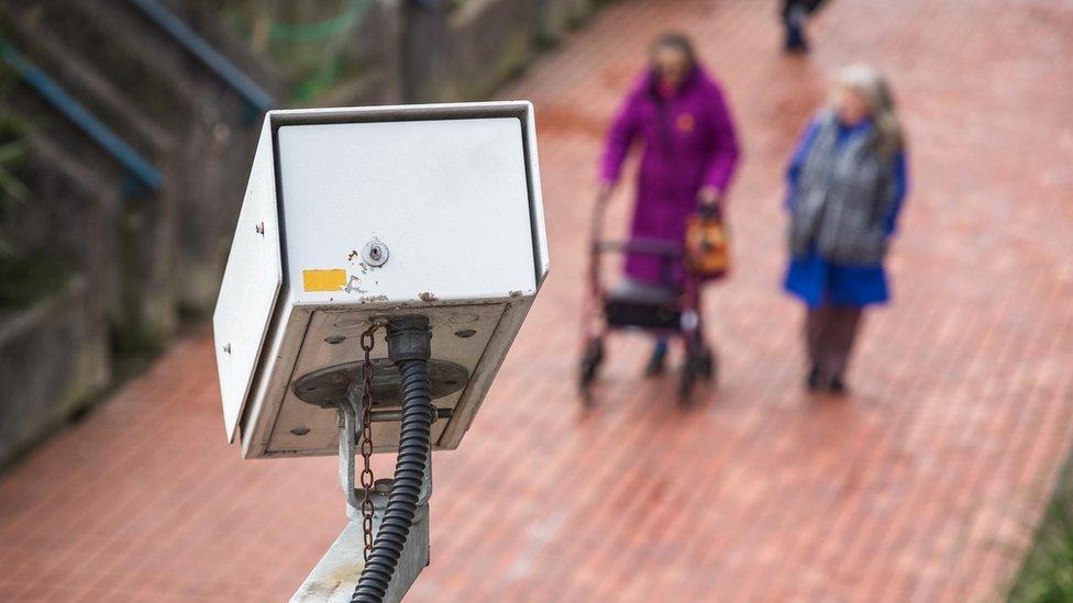 A security camera watching a street