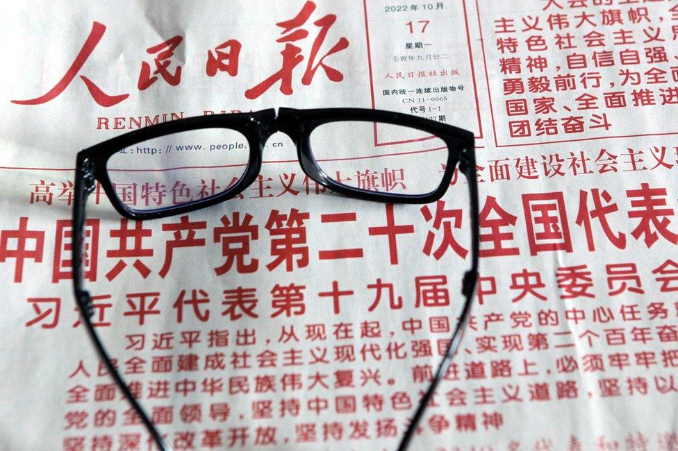 A citizen reads a newspaper to learn about the report of the 20th Communist Party of China (CPC) Congress in Shenyang, Liaoning province, China, Oct 17, 2022.