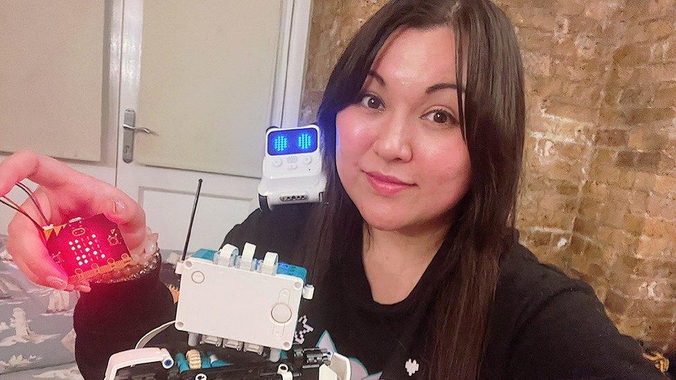 The BBC's Mary-Ann Russon poses with a collection of computer programming toys