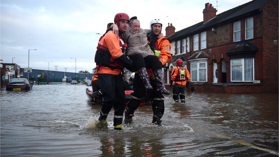 Members of the Fire and Rescue service evacuate a man in Doncaster