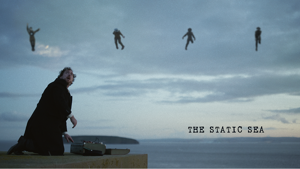 Photo of radio engineer with ghosts in sky above the sea