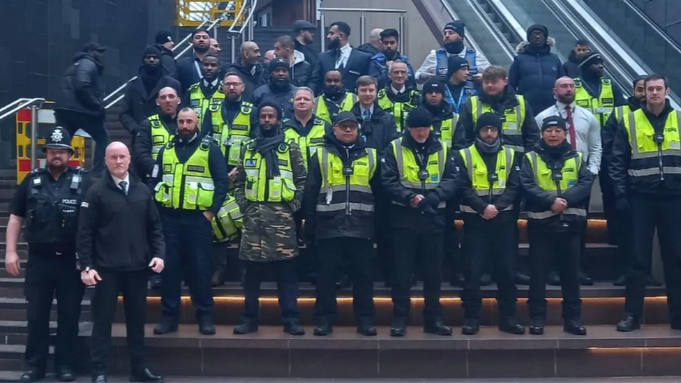 Police and security staff standing on the steps at Cabot Circus shopping centre in Bristol