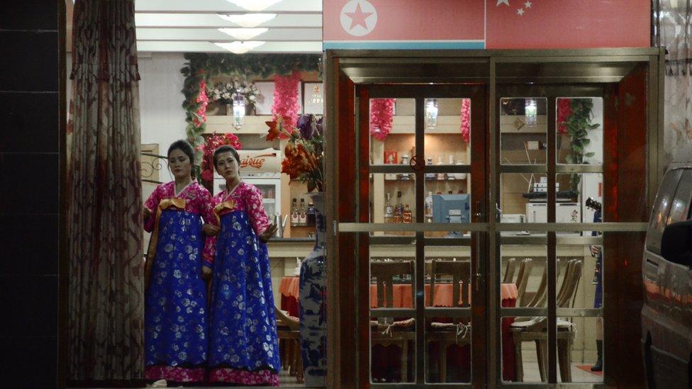 North Korean hostesses waiting for customers at the entrance to a restaurant in the Chinese border city of Dandong.