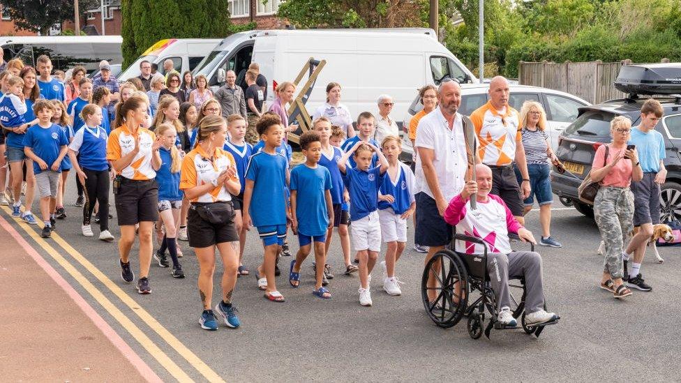 Glyn Bennett takes part in The Queen's Baton Relay as it visits Uttoxeter as part of the Birmingham 2022 Queens Baton Relay on July 20, 2022 in Uttoxeter