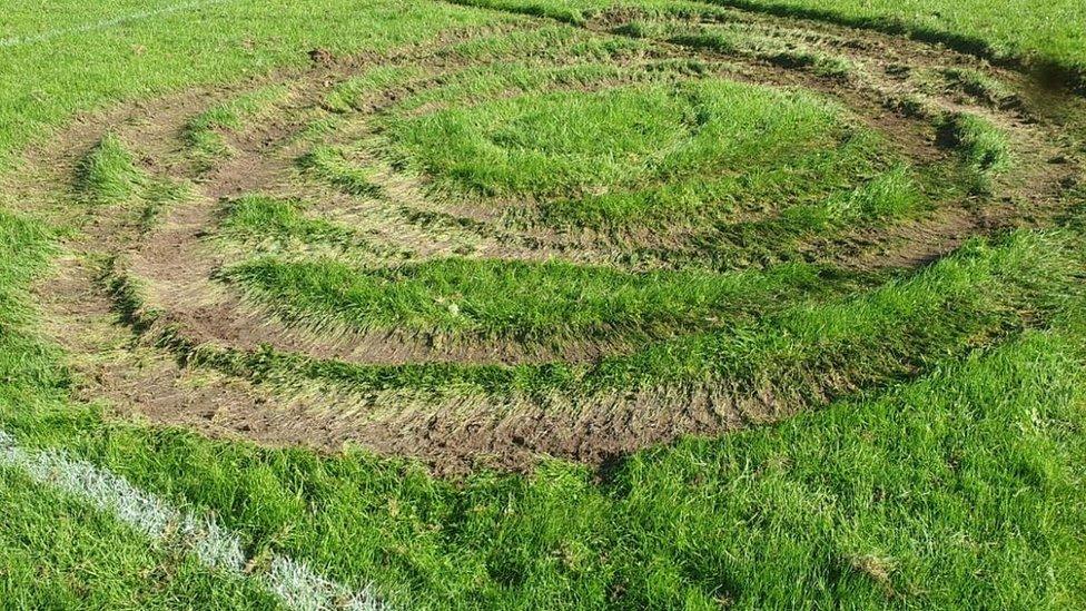 Tyre tracks on football pitch