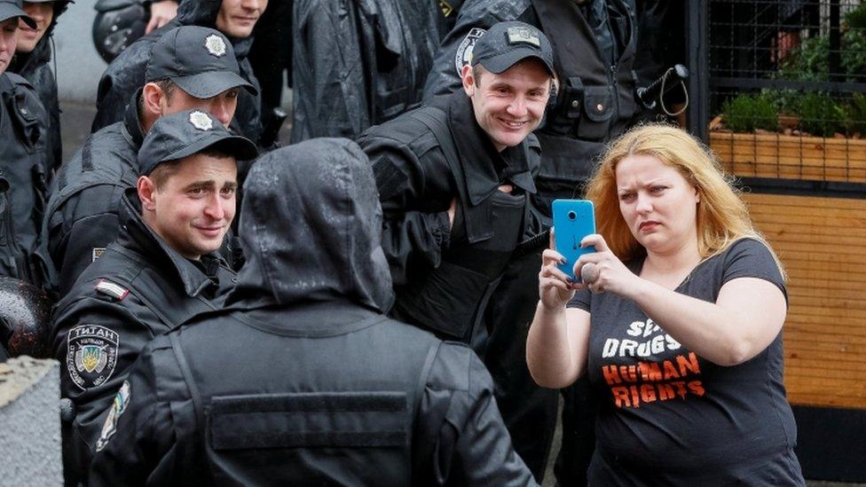 An activist takes a selfie with Ukrainian riot police