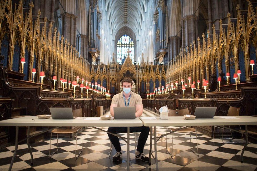 Staff wait for patients at a new Covid-19 vaccination site in Westminster Abbey, London. 10 March 2021