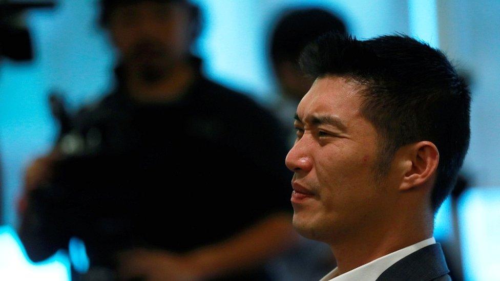 Future Forward Party leader Thanathorn Juangroongruangkit reacts as he watches Thailand's constitutional court's ruling at the party's headquarters in Bangkok