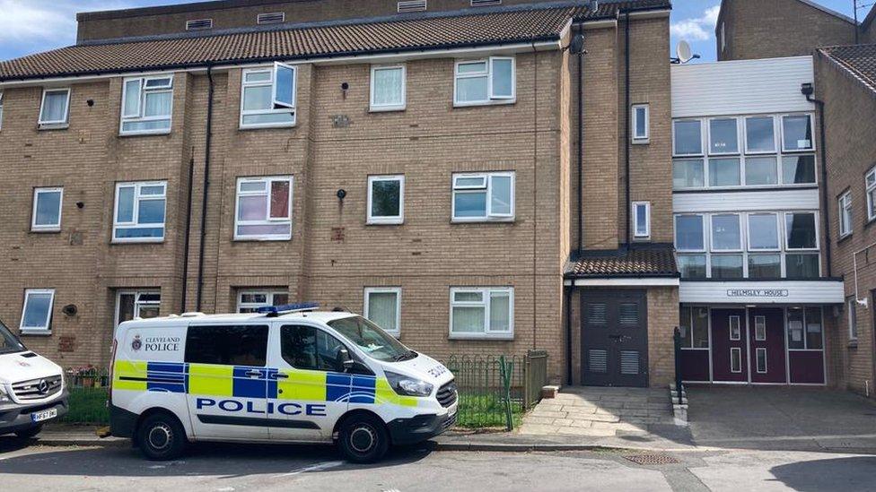 Police vehicles parked outside Helmsley House