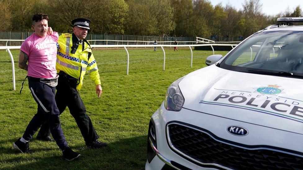 Protesters are detained by police during day three of the Randox Grand National Festival at Aintree Racecourse, Liverpool.