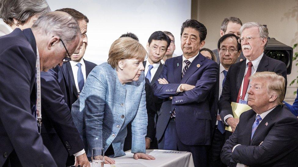 German Chancellor Angela Merkel with US president Donald Trump on the sidelines of the official agenda on the second day of the G7 summit on 9 June 2018 in Canada