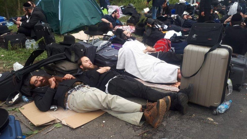 Jewish pilgrims, who plan to enter Ukraine from Belarus, rest in a neutral zone near the Novi Yarylovychi crossing point