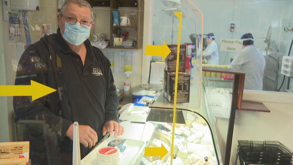 Business owners in his cheese shop