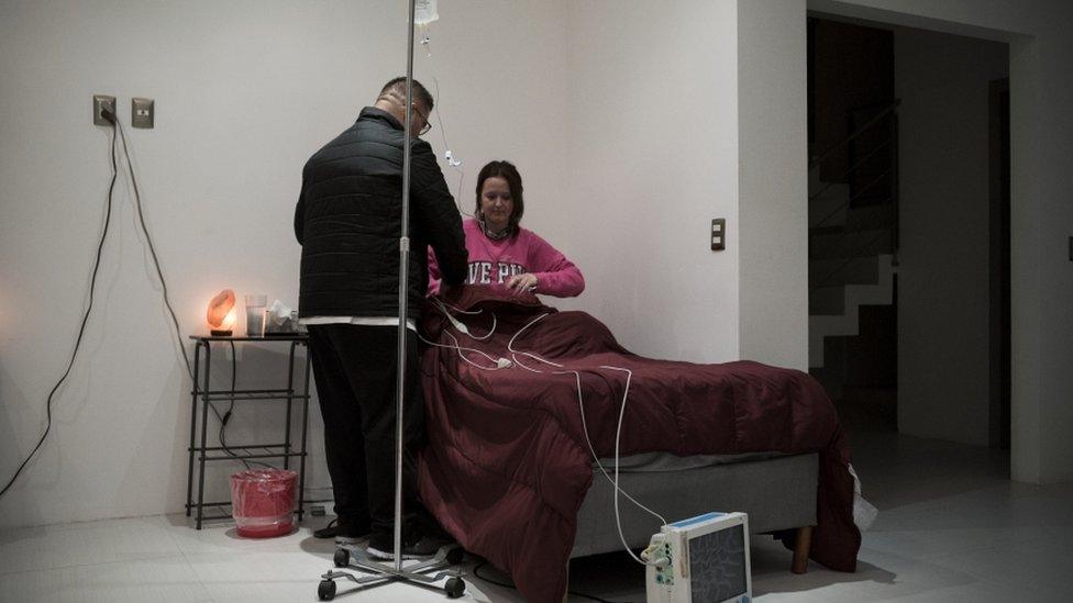 Emily Albert is hooked up to an EKG before she begins her ibogaine treatment Credit: Jonathan Levinson/PRI