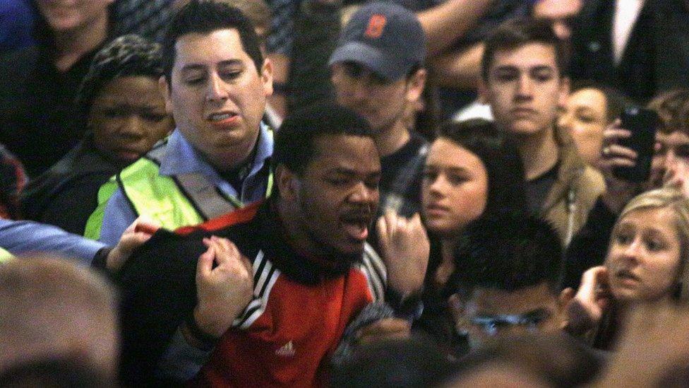 A protester is removed by police during Republican presidential candidate Donald Trump's speech at a campaign rally in St. Louis (11 March)