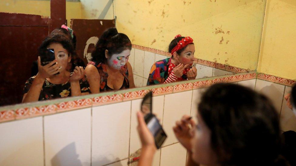 Clowns prepare themselves to take part in a parade during Peru's Clown Day celebrations in Lima, Peru May 25, 2018