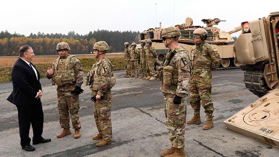 US Secretary of State Mike Pompeo talks to US soldiers as he visits the military base in Grafenwoehr, Germany, in 2019