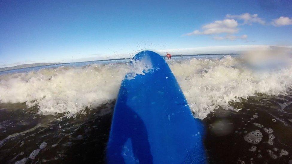 surfboard crashing against the waves